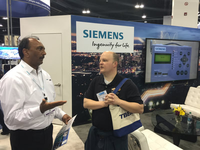 Naeem Siddiqui of Siemens discusses circuit breakers with a Siemens/Deloney customer.